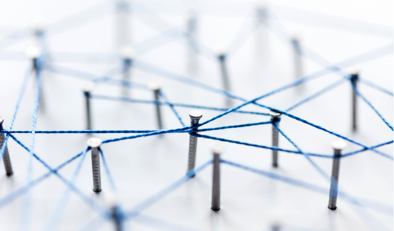 Photo of nails on a board with blue string connecting the heads.