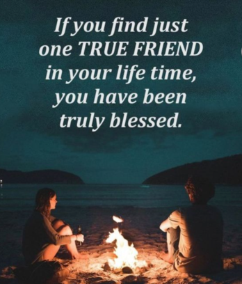 Two friends sit outside in the dark with a campfire, overlooking a lake. White text overlays the image, and reads as follows: "f you find just one true friend in your life time, you have been truly blessed"