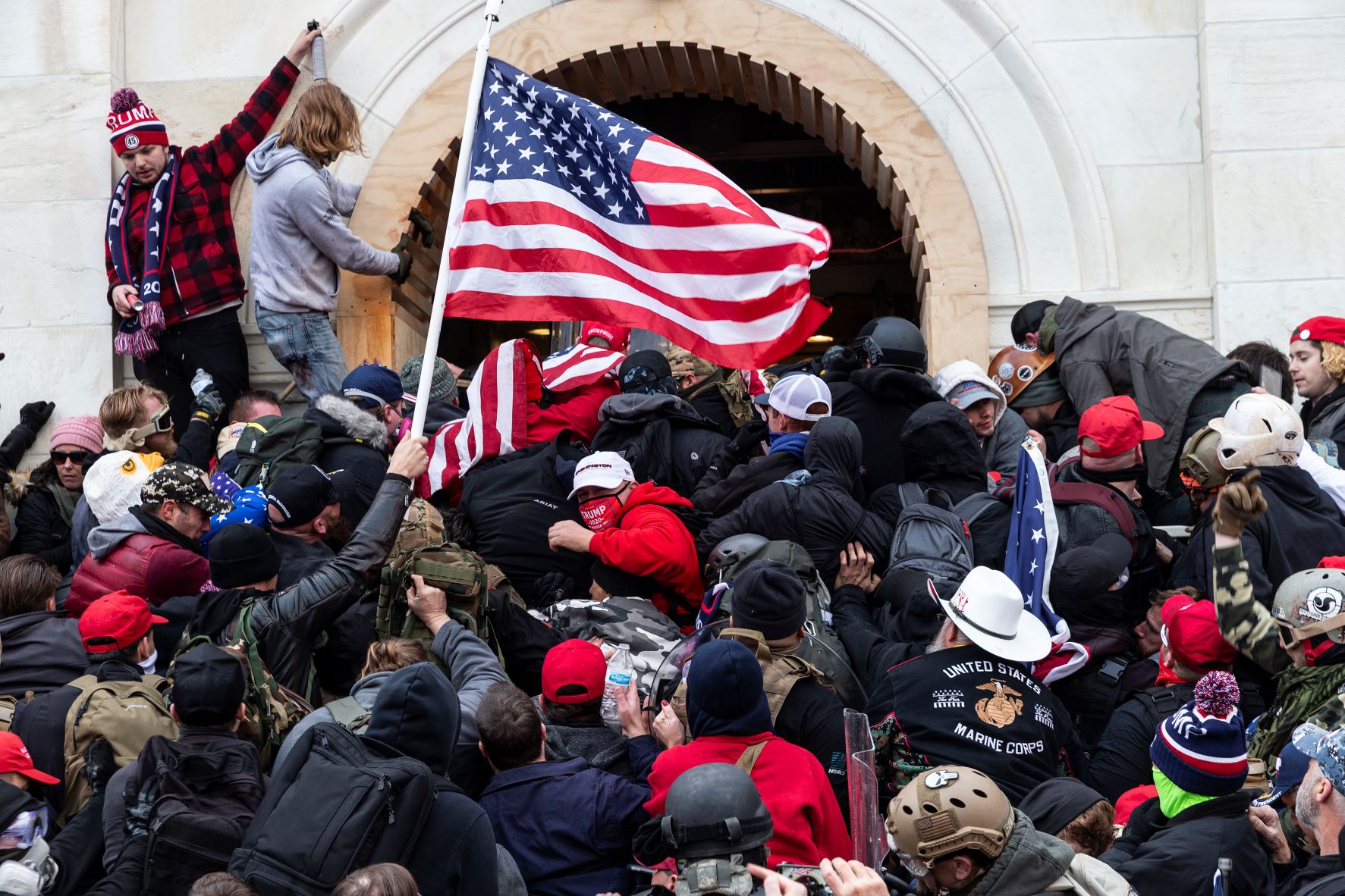Capitol rioters breeching an entrance to the United States Capitol on January 6th, 2021.