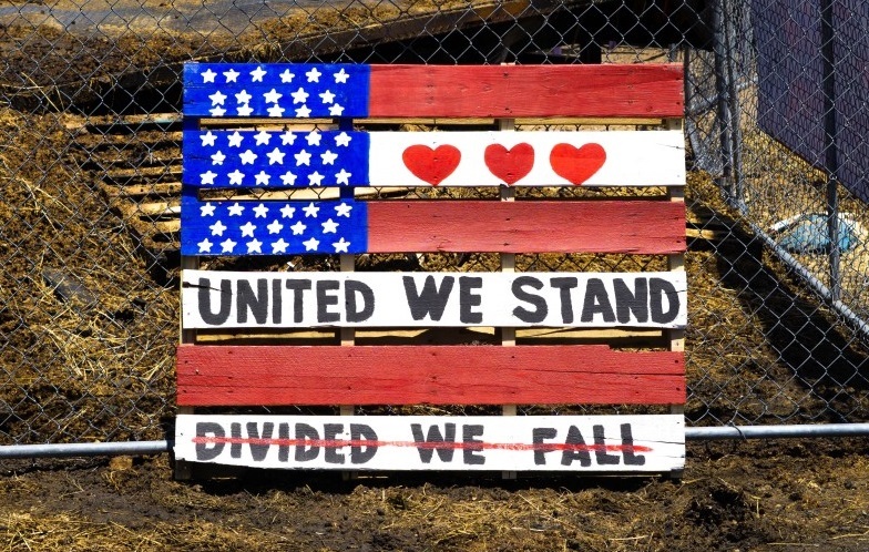 United We Stand sign on American Flag