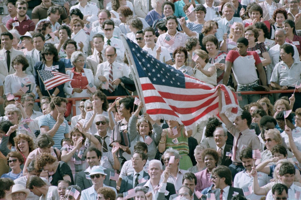At Orange Bowl Stadium, immigrants demonstrate their patriotism during what could be the largest naturalization ceremony in American history. c. 1984 (GettyImages).